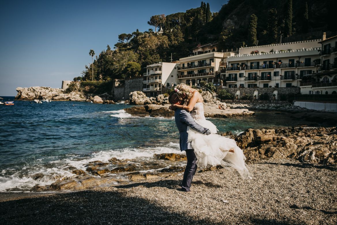 wedding couple at the beach at hotel Sant Andrea in Taormina